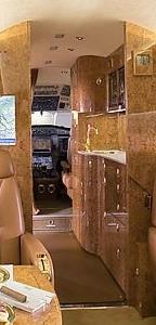 INTERIOR 10 passenger configuration with seats finished in Royal Hide Caramel Leather, featuring a forward four place club 20 inch seats, aft four place dining group 18 inch seats, and an aft two