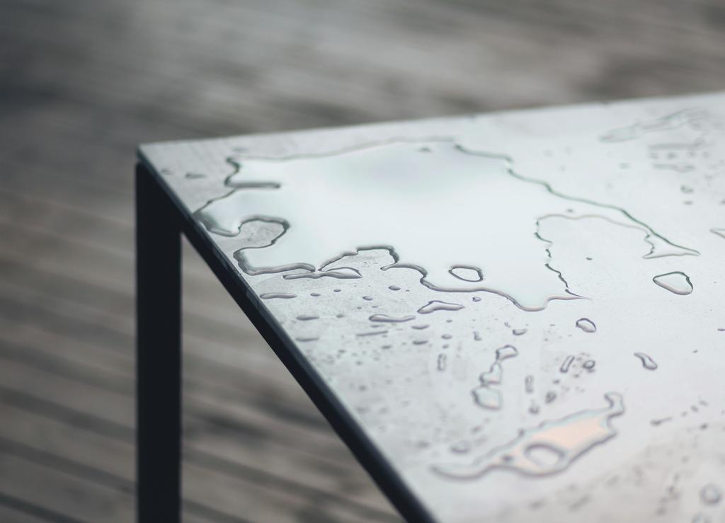 Although concrete is generally considered to have a very rough and massive appearance, this tabletop is slim and the concrete has a smooth, hand polished finish.