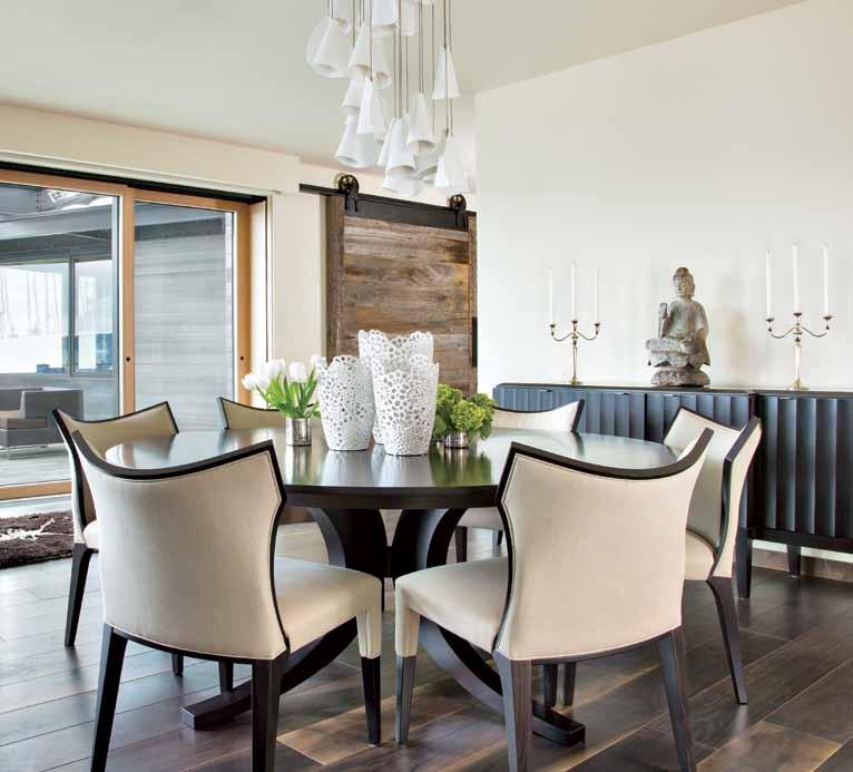 The Costantini Pietro chairs are covered in a lightweight taupe linen, and the pods on the sculptural light fixture can be unscrewed and rearranged.