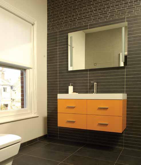 It may cost you extra, but it gives you peace of mind knowing that all work will be completed to a professional standard Left: Black slate tiles juxtoposed with a bright orange bathroom cabinet in