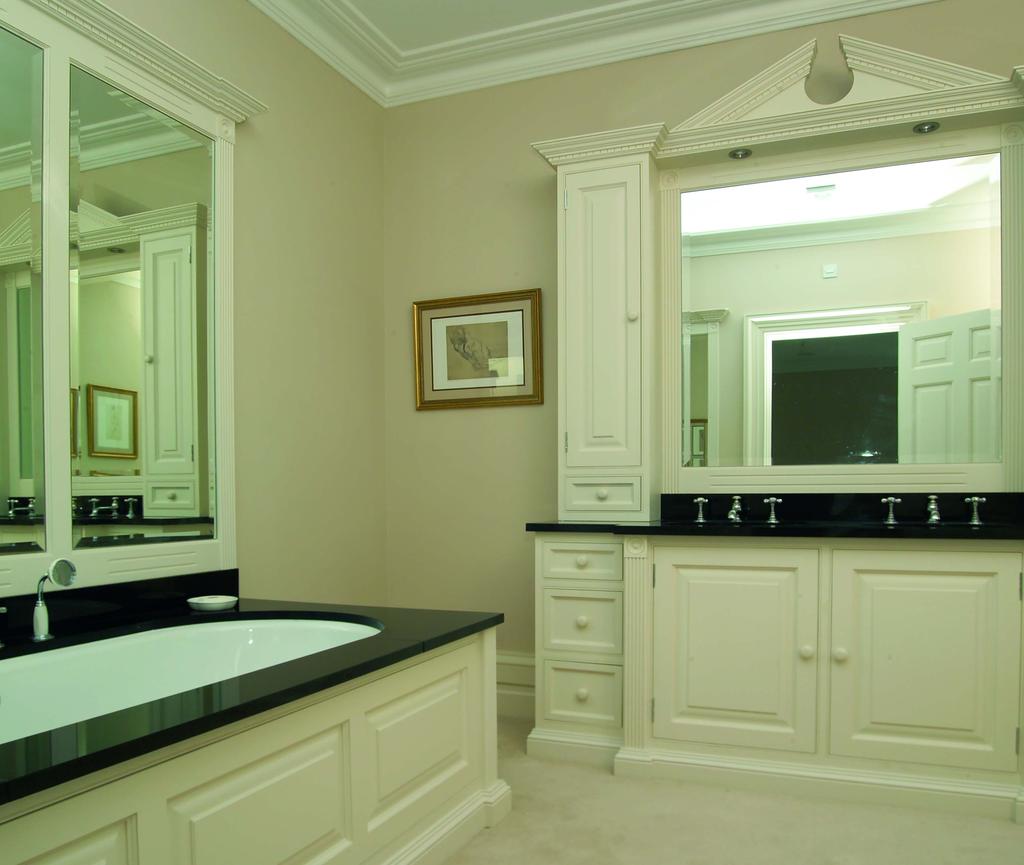 Large mirrors also enhance the bath and vanity areas