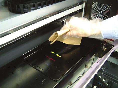 7. Open the left maintenance cover. 8. Wipe off the waste ink from the flushing tray with the paper towel containing washing liquid.