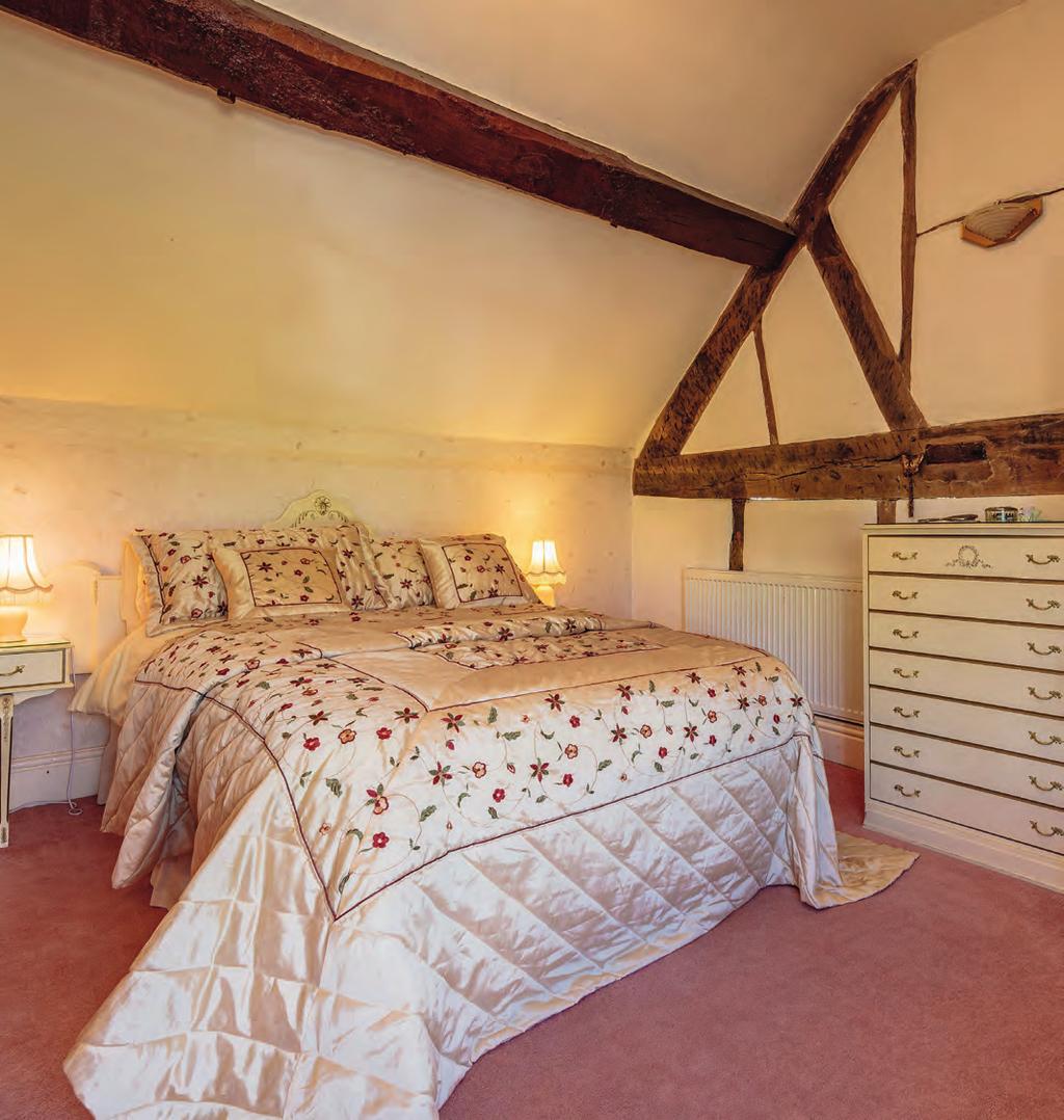 Bedroom Two: Superb views over the river towards distant hills, feature fireplace, exposed beams, radiator.