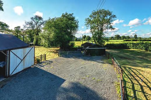 On the opposite side of the lane is a large parking and turning space which gives access to the large modern outbuilding and the timber workshop as well as two paddocks, there is also a field on this