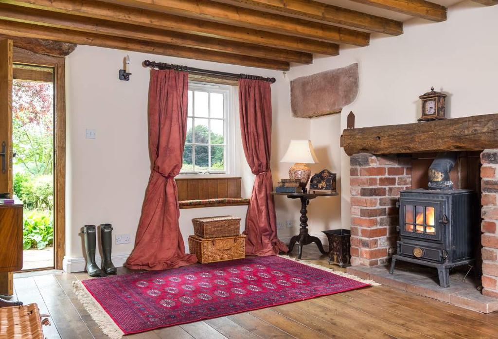 The dining room has an open fire with attractive oak and sandstone surround
