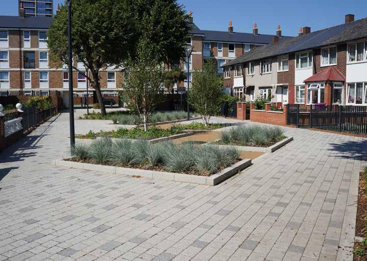 A bland, under-used pedestrian area separating two rows of houses has been brought to life with a diagonal design of planters surrounded