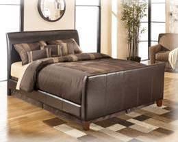 (150/71/98) B465 Stanwick (Signature Design BED ONLY) Fully upholstered faux brown leather panel bed Button tufted accents Can be used with many domestic and import bedroom groups Beds available: