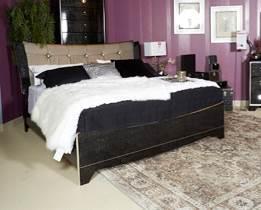 this bedroom group Black glossy finish highlighted with pearl over replicated spiral ash grain Headboard upholstered in a bright silver color with faux crystal buttons Case pieces and bed accented in
