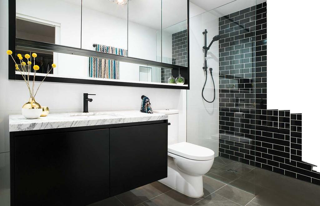 BATHE AT ITS BEST Bathrooms feature stone or marble benchtops, black tapware and frameless glass shower screens with feature