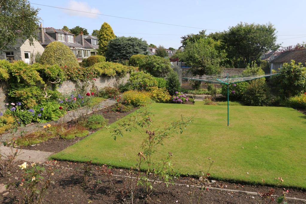 There is a substantial paved area to the rear of the property with a beautifully maintained