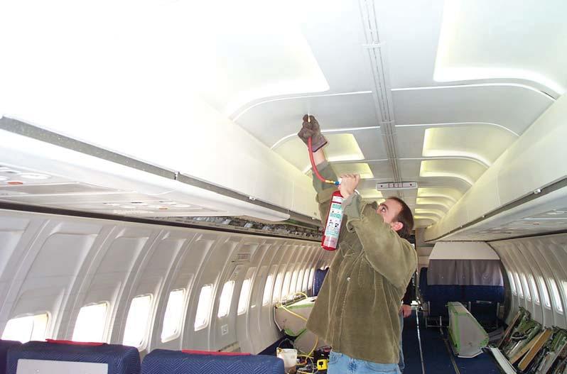 TESTING IN THE NARROW-BODY AIRCRAFT CABIN OVERHEAD AREA. After lighting all six candle lanterns, the ceiling panels were quickly reinstalled to their proper position. The 2.