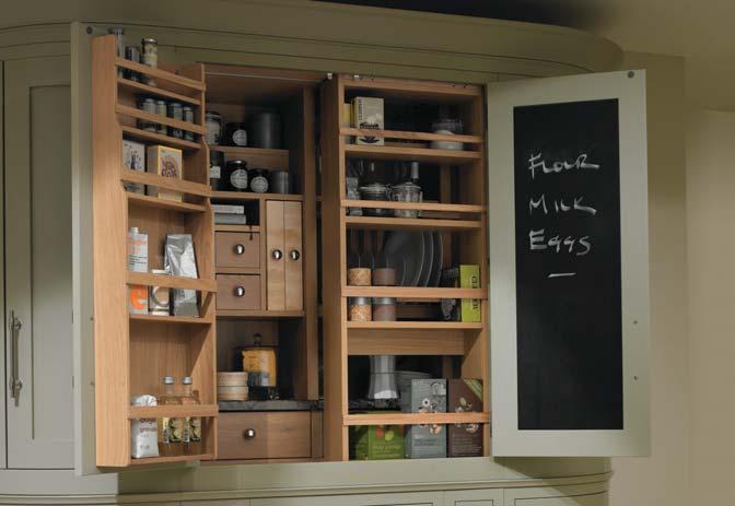 The full-height pantry has a sliding rack at its heart, concealing a pull-out chopping board, hanging for wine glasses, a plate rack plus storage for spices, recipe books and breakfast