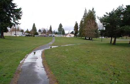 A small gravel parking area adjacent to the community garden is access from S. Puget Sound Ave.