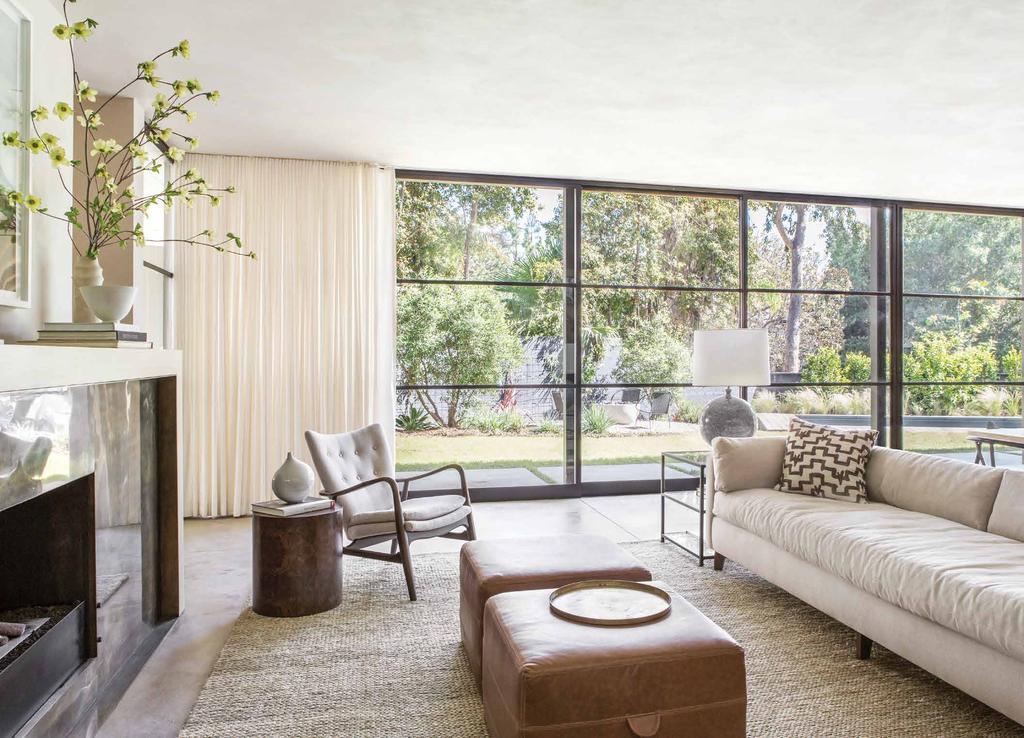 In the living room of a Rustic Canyon house, designers Krista Schrock and David John Dick situated a custom sofa covered with a Romo cotton denim from Thomas Lavin, a vintage Danish armchair in