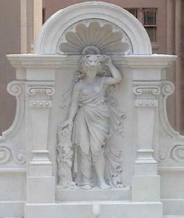 Her allegorical female figure reigns atop the building, holding Hercules club and wearing his lion skin.