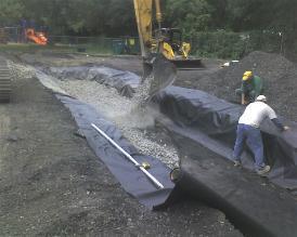 Line trench with heavy pervious geotextile fabric and