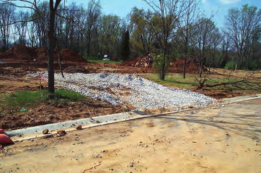Rock pad was installed properly with right sized rock, but lack of filter fabric underliner is causing rock to spread and sink into the soil.