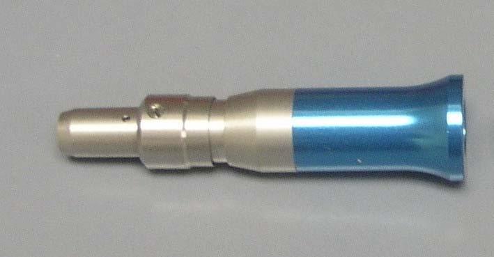 B) The prophy angle is placed on the straight handpiece with the cut out portion (at the base) placed over the raised bubble on the straight handpiece.