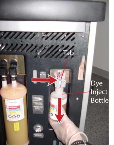6. Remove the dye inject bottle by squeezing the tab of the quick-disconnect, and then pulling the bottle down and away from the fitting.