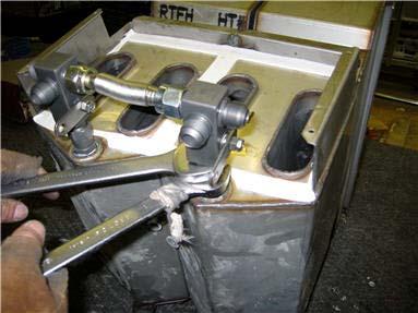 Tighten the return valves using 1 1/8 wrench on return valve and 1 wrench