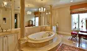 The 7-piece ensuite features marble tile flooring, His and Hers vanities with marble countertops and under mount sinks, step up whirlpool tub with decorative columns and