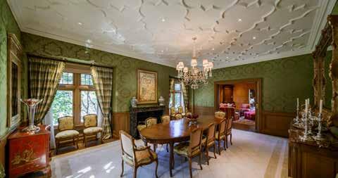 To the left of the sitting room/foyer, the banquet size formal dining room is highlighted with ten and a half foot ceilings,