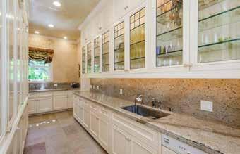 It boasts granite countertops, granite backsplash, stone floors, a Sub-Zero refrigerator/freezer, Miele dishwasher, two sinks, two garbage disposals, a hot water dispenser, lovely hand painted