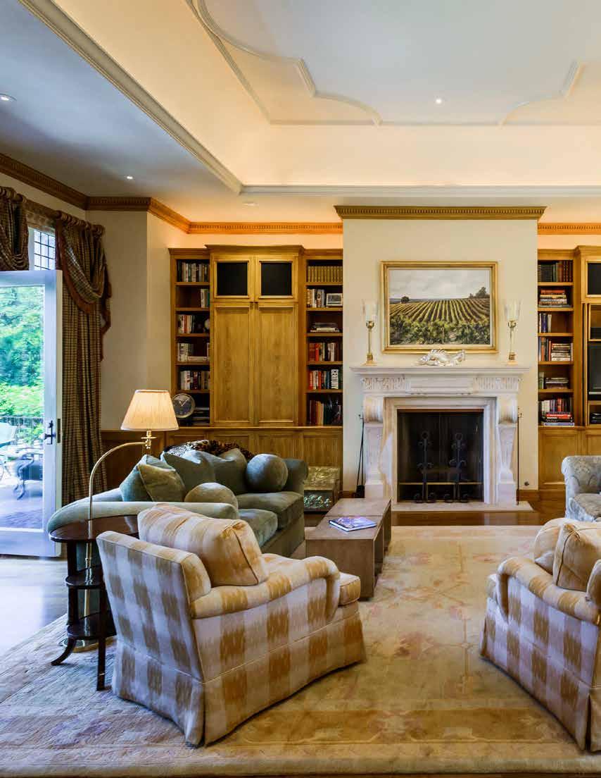leaded glass windows, intricate ceiling moldings, recessed lighting, overhead lighting, wainscoting, built-in bookshelves and entertainment