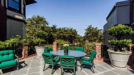 walk-out tiled deck with Presidio views, lighting and overlooking the backyard/garden.