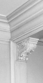 When it is used as a balcony support, or as a modillion supporting the corona of a cornice, it is recumbent; when supporting the cornices of windows and doors, its attitude is erect.