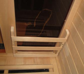 2. If your sauna comes with the optional Magazine Rack and/or optional Towel Rack, use the screws provided to mount the Magazine Rack in the lower left hand side of the interior FRONT WALL PANEL (in
