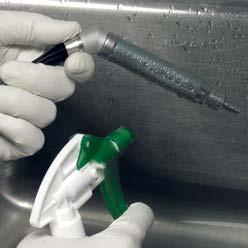 With distal end pointing down, spray and wipe the handpiece with the cleaning solution for a minimum of 2 minutes.