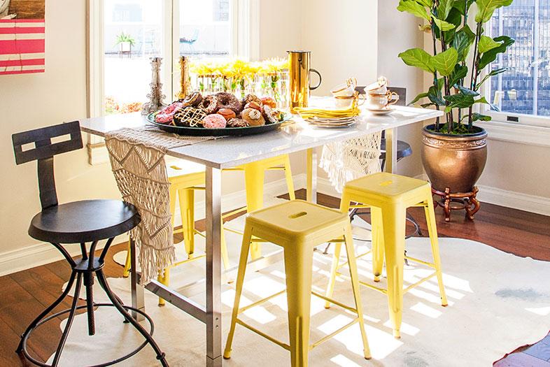 The designer topped an Ikea table base with a custom terrazzo slab. She found the tolix-style galvanized-metal stools at overstock.com and spray-painted them chartreuse.