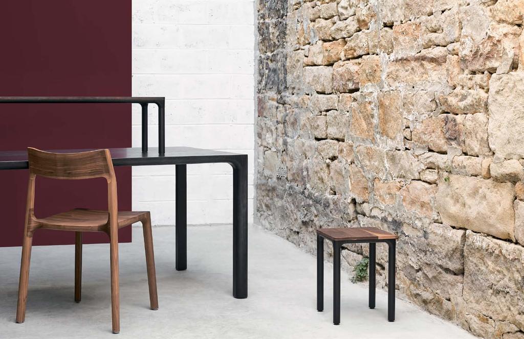 adam goodrum molloy 46 molloy chair in walnut molloy dining table in black stained ash molloy modular coffee table in black stained ash and black powdercoat legs molloy modular stool in walnut and