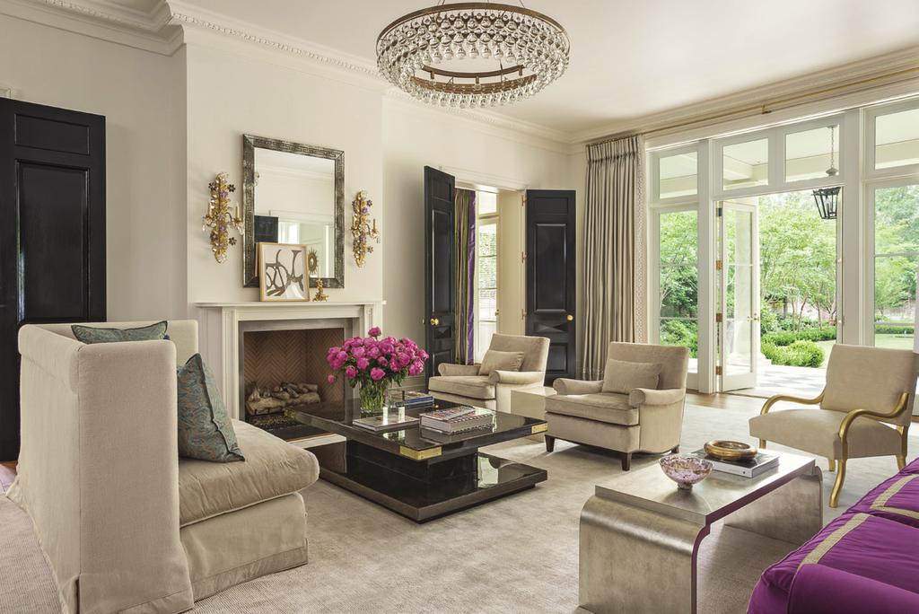 Neutral upholstered seating in the living room includes a pair of Jonas custom armchairs, a single gilded chair covered in Fortuny fabric, and a custom John Saladino sofa.