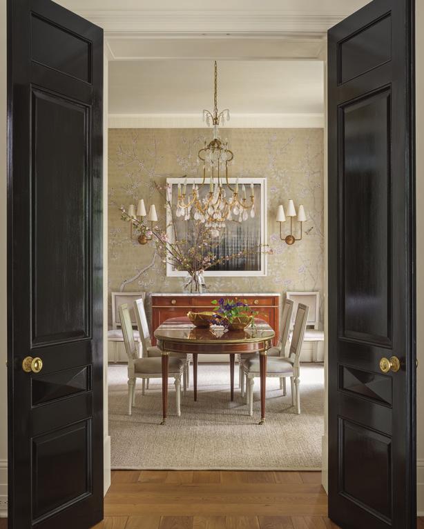 Custom de Gournay wallcovering in tarnished silver envelops the dining room.