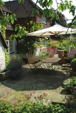 A Cottage Garden A delightful cottage with a modern extension needed help to integrate home and garden.