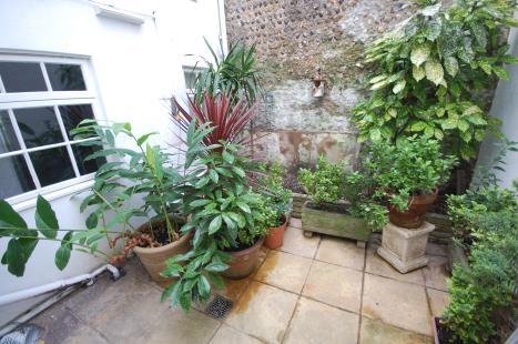 8 OUTSIDE SMALL ENCLOSED PATIO: Paving and raised flowerbeds.