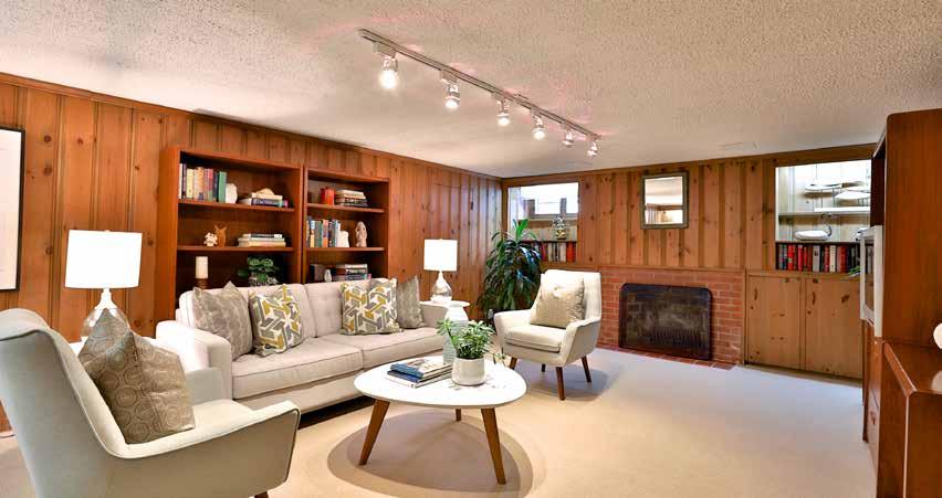 HW HW LOWER LEVEL RECREATION ROOM High end broadloom Wood burning fireplace with ceramic tile hearth Paneled walls Built-in shelving Above grade