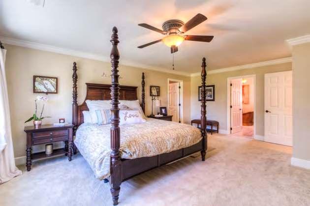 Bedroom windows w/views Carpet Crown molding Ceiling fan