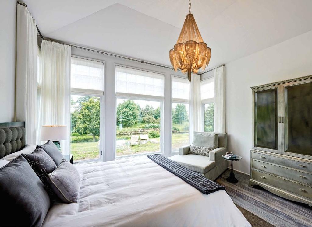 room with a view From top: Overlooking a pond, the master suite is light and airy with masculine and feminine touches for balance; design partners Jamie Schachtel (left) and Danielle Yucht.