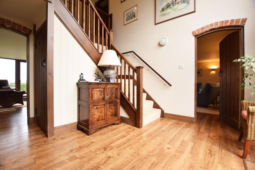 The ground floor also compromises a stunning entrance hall with full height glazing overlooking the front gardens, a ground floor cloakroom, sitting room with open fire, spacious dining room, study
