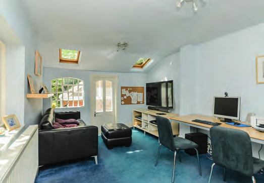 This room is incredibly light and spacious and has large porcelain floor tiles, and is fitted