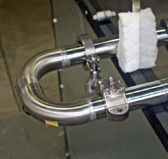 3. Attach the upgrade tube to the syrup pan using one of the clamps and Teflon washers from the u tube that was removed.