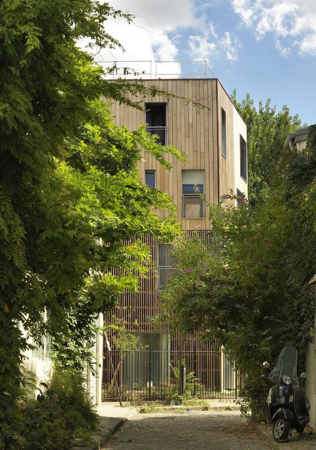 «the wooden building belongs to the greener environment in the garden