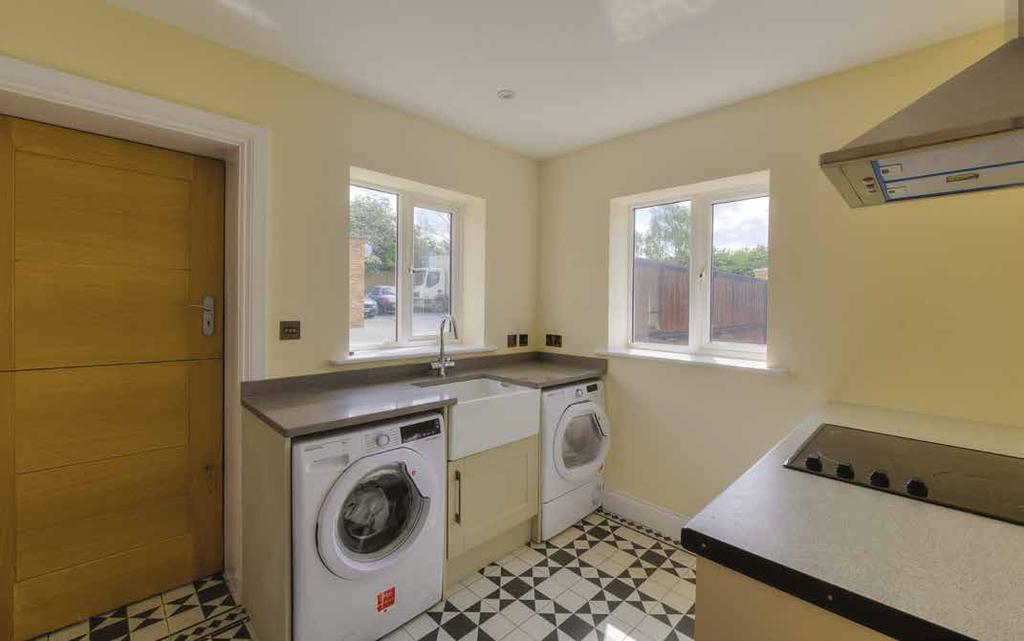 UTILITY ROOM Window to side and front aspects. Stable door to side aspect. Range of base mounted units with granite effect worksurfaces.