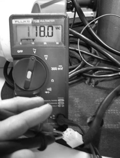 Check for voltage at the damper harness connection. Use a volt meter set to read line voltage (see picture below). There should always be 102 to 132 volts between black and white wires.
