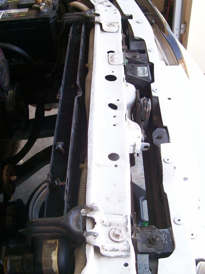 3) Remove the radiator. Using the 3/8 wrench, loosen the radiator bracket bolts and remove the brackets.