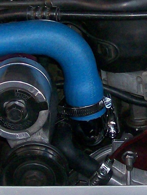 Using the 5/16 nut driver, connect the lower radiator hose to the