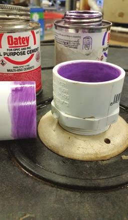 FIGURE 3. Gluing PVC pipe. 3a: The clean pipe with no burs is primed with purple primer on both surfaces, then, 3b, glue is applied to both surfaces.